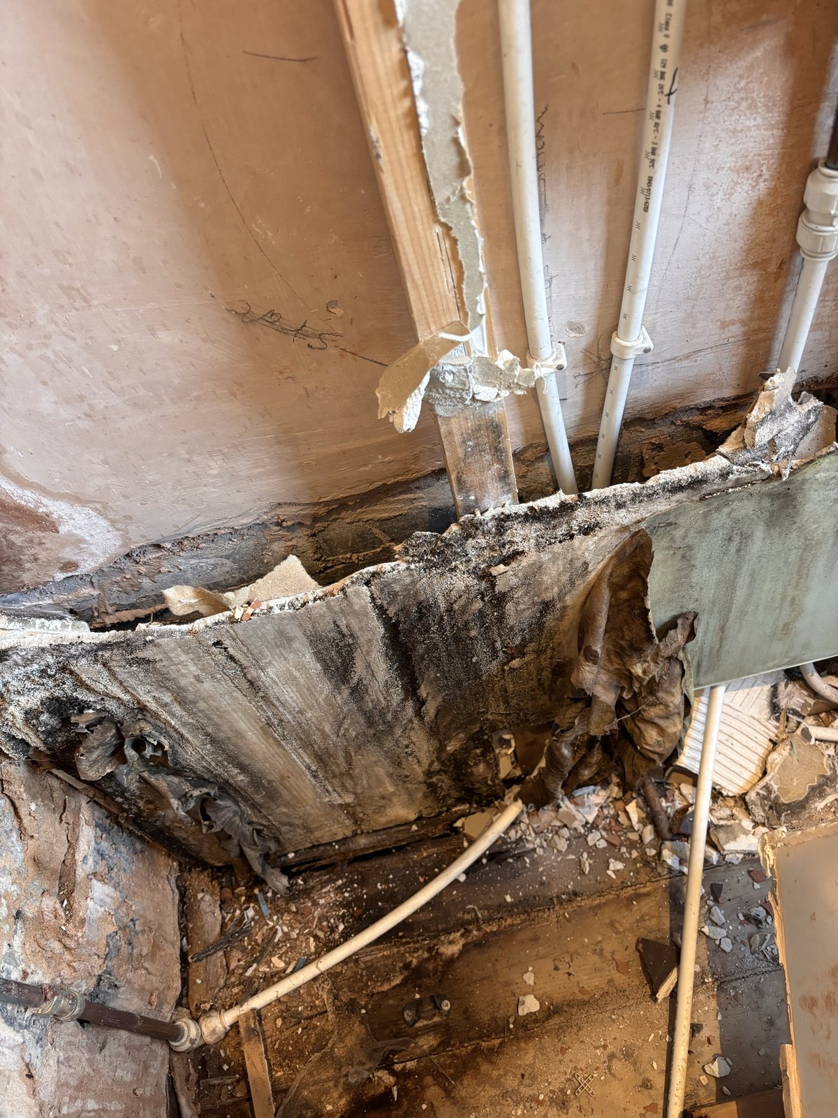 Before: water damage discovered behind the old panels
