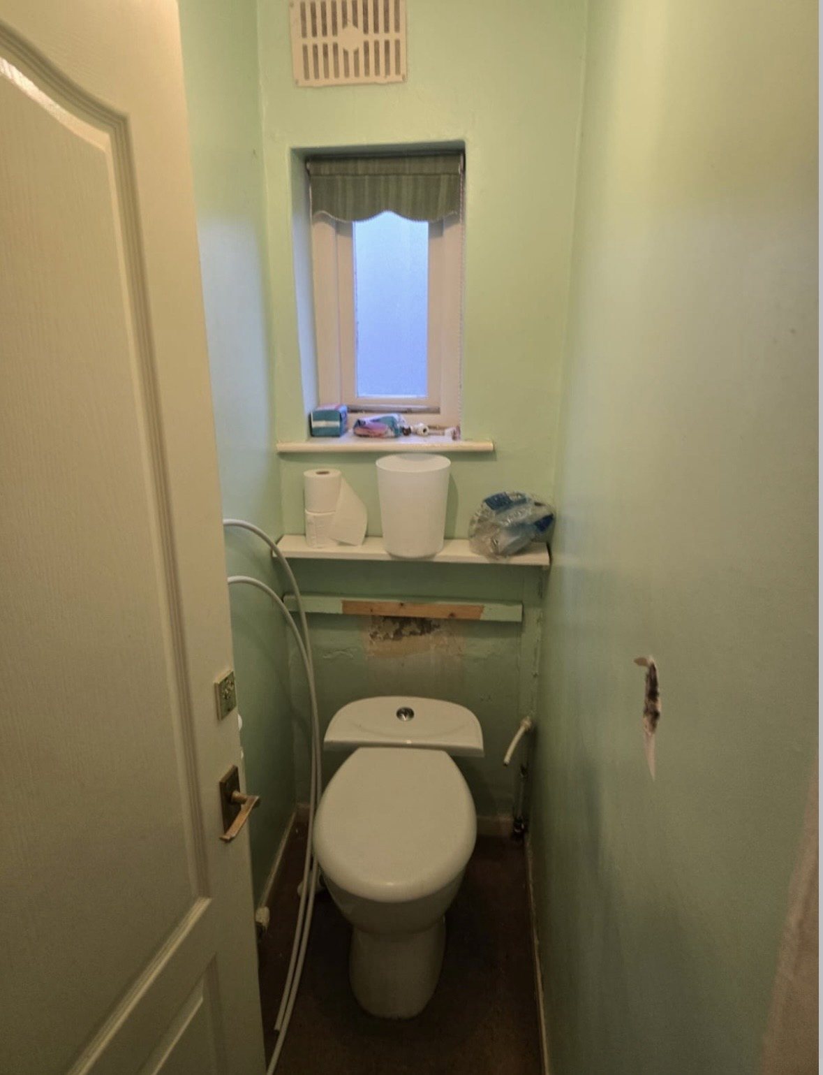 Before: separate mint-green toilet room