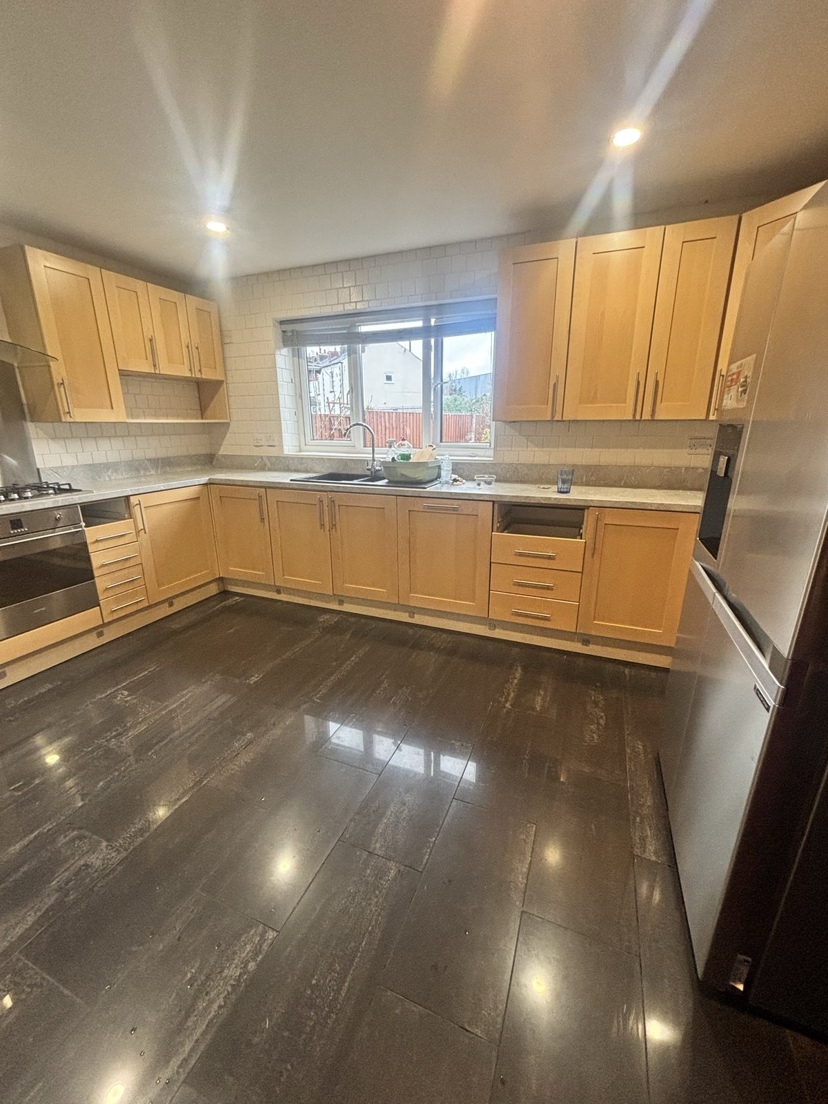 Kitchen before: dated light-oak shaker units