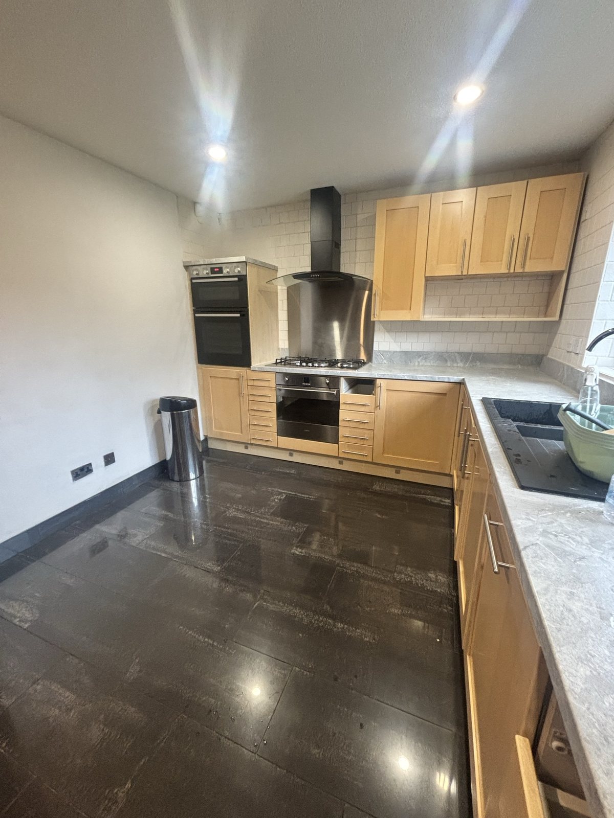 Kitchen before: oven and hob with light-oak units
