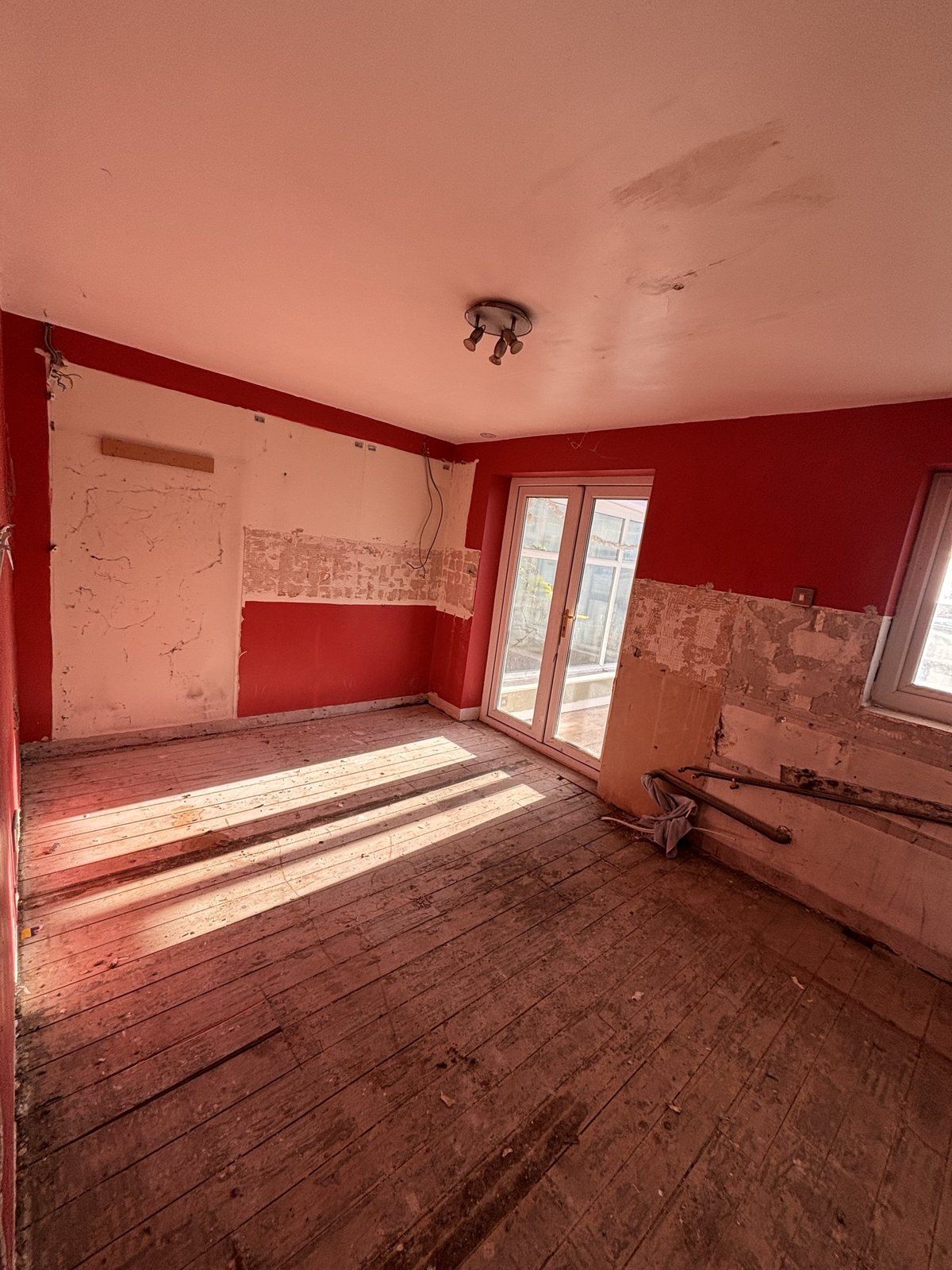 Kitchen before: stripped room with French doors