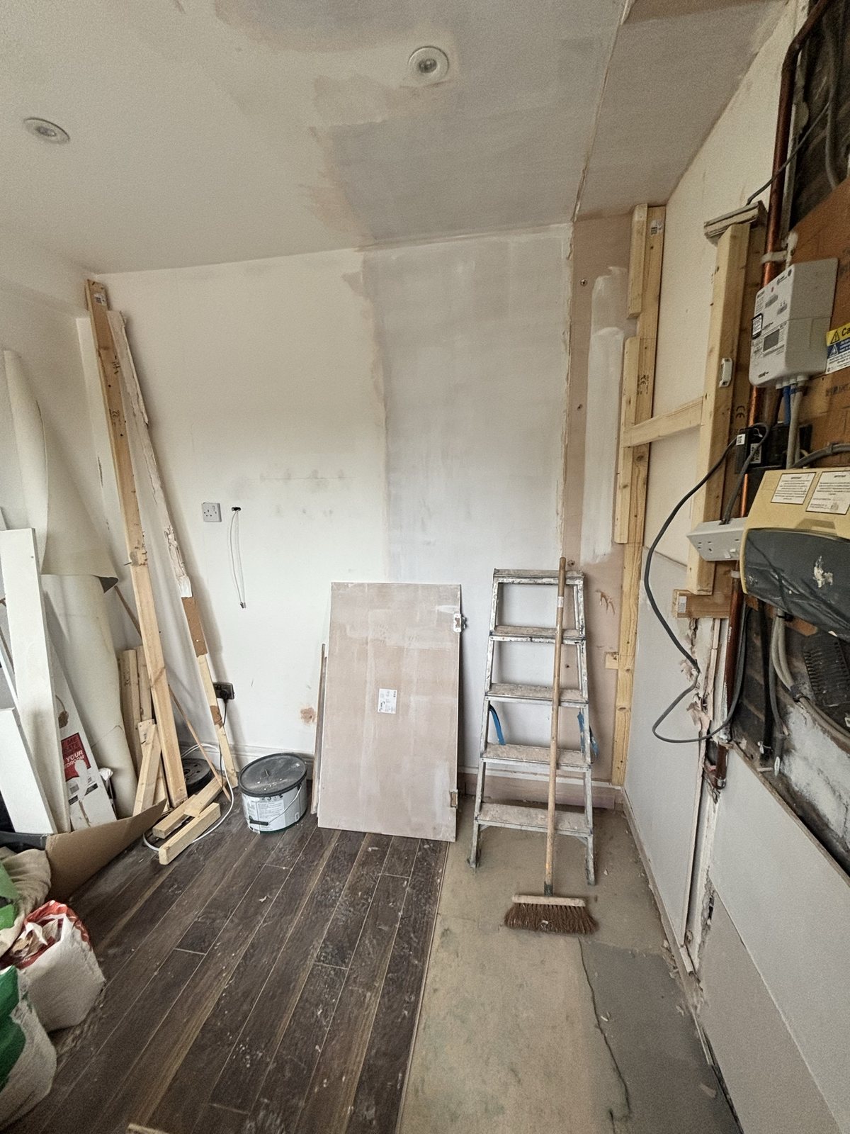 Media wall before: bare room, stud work and first fix