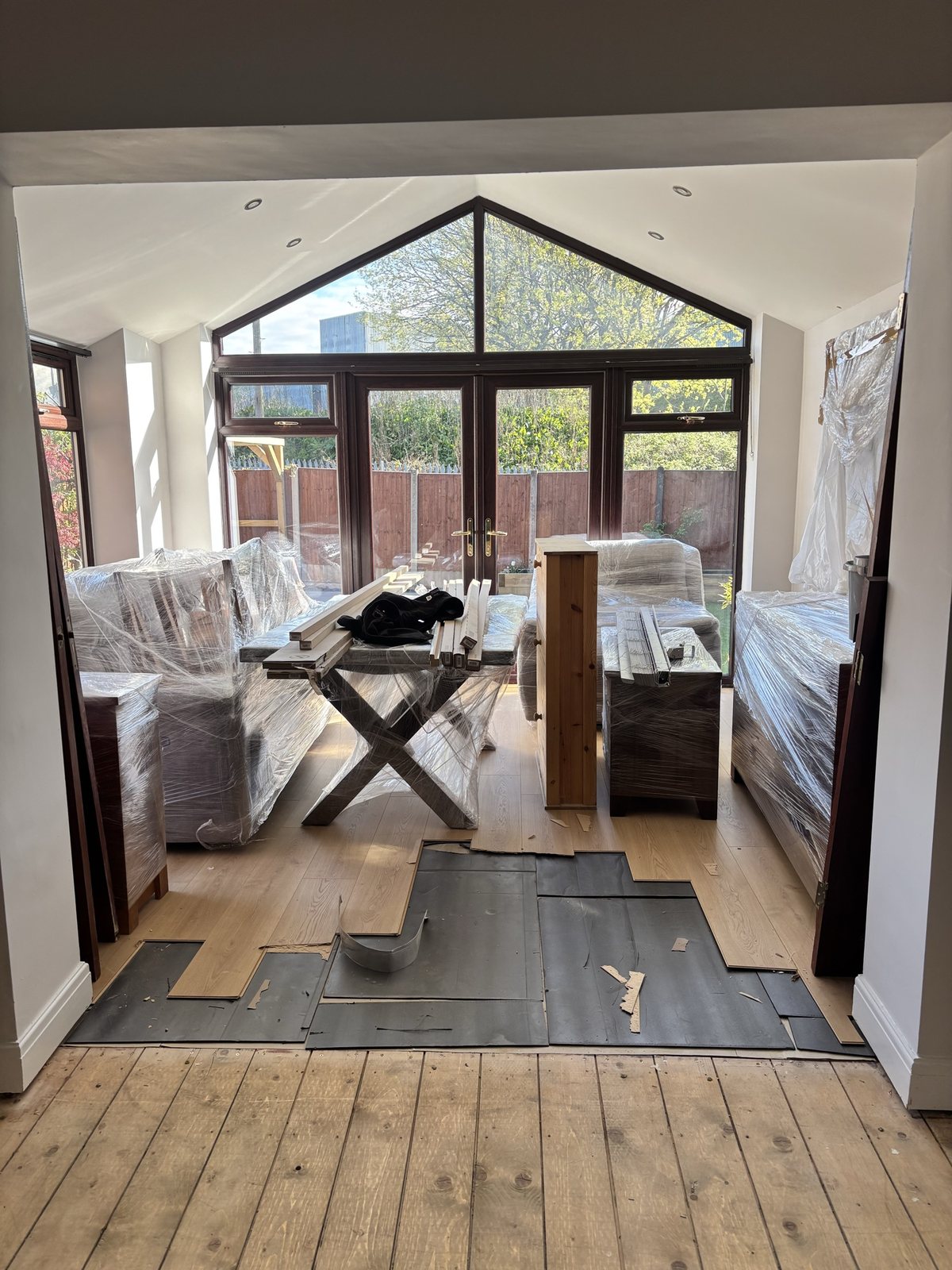 Conservatory before: laminate being laid, furniture protected