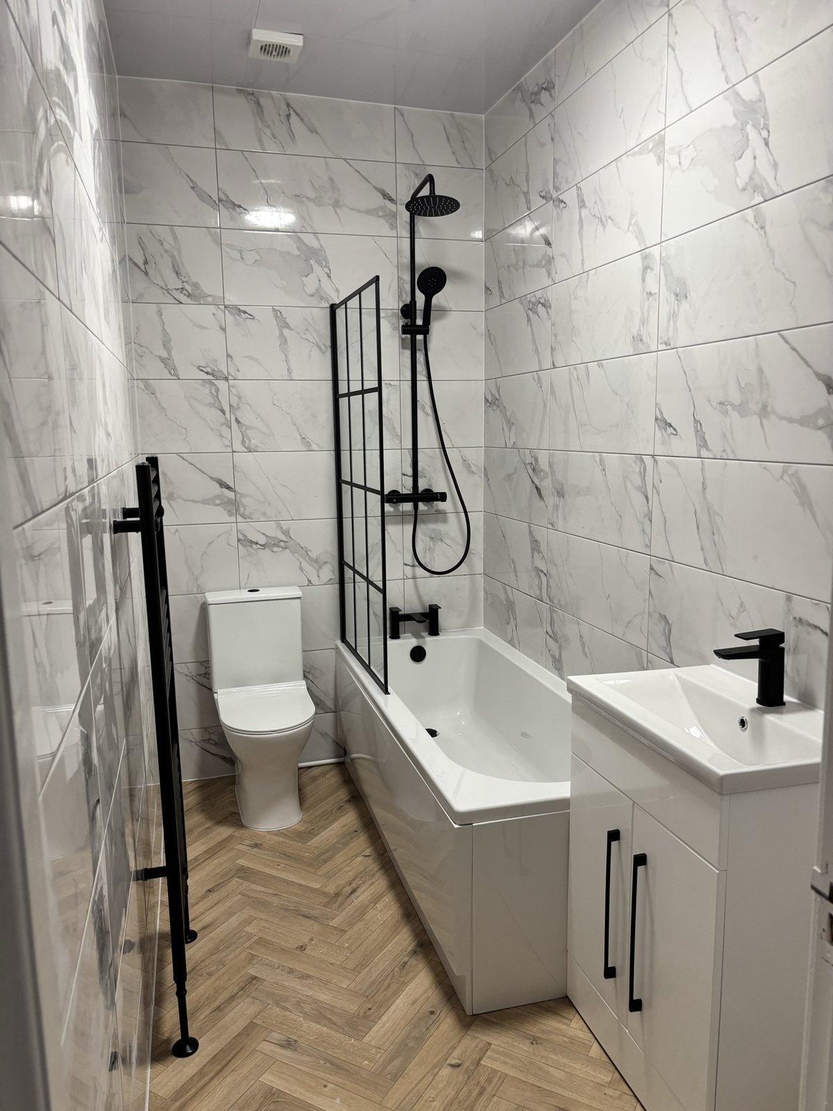 After: marble-effect tiles, matte black fixtures and Crittall screen