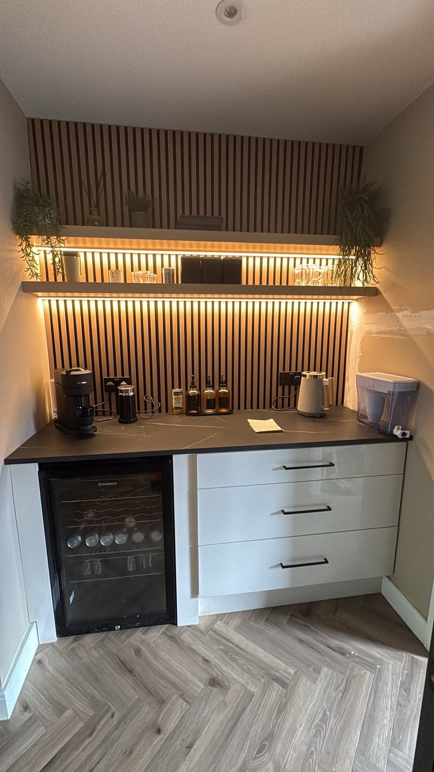 Bespoke coffee station with slatted joinery and floating shelves, after