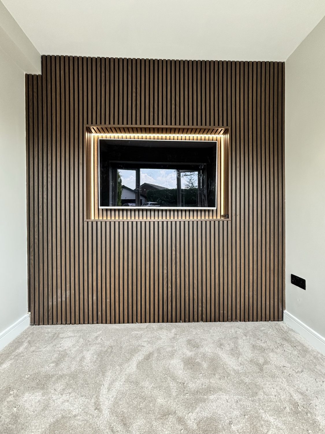 Architectural media wall with lit TV niche and bespoke joinery, after