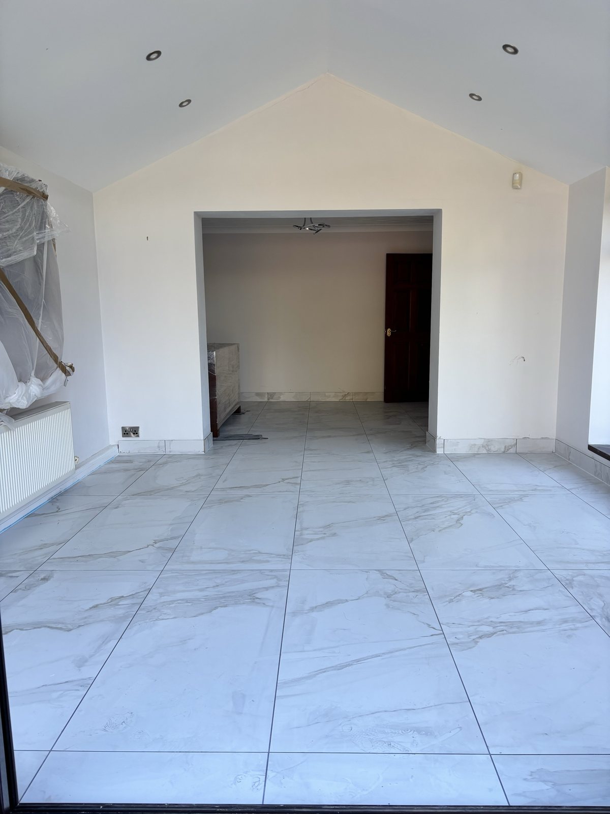 After: porcelain tiled floor and matching skirting throughout